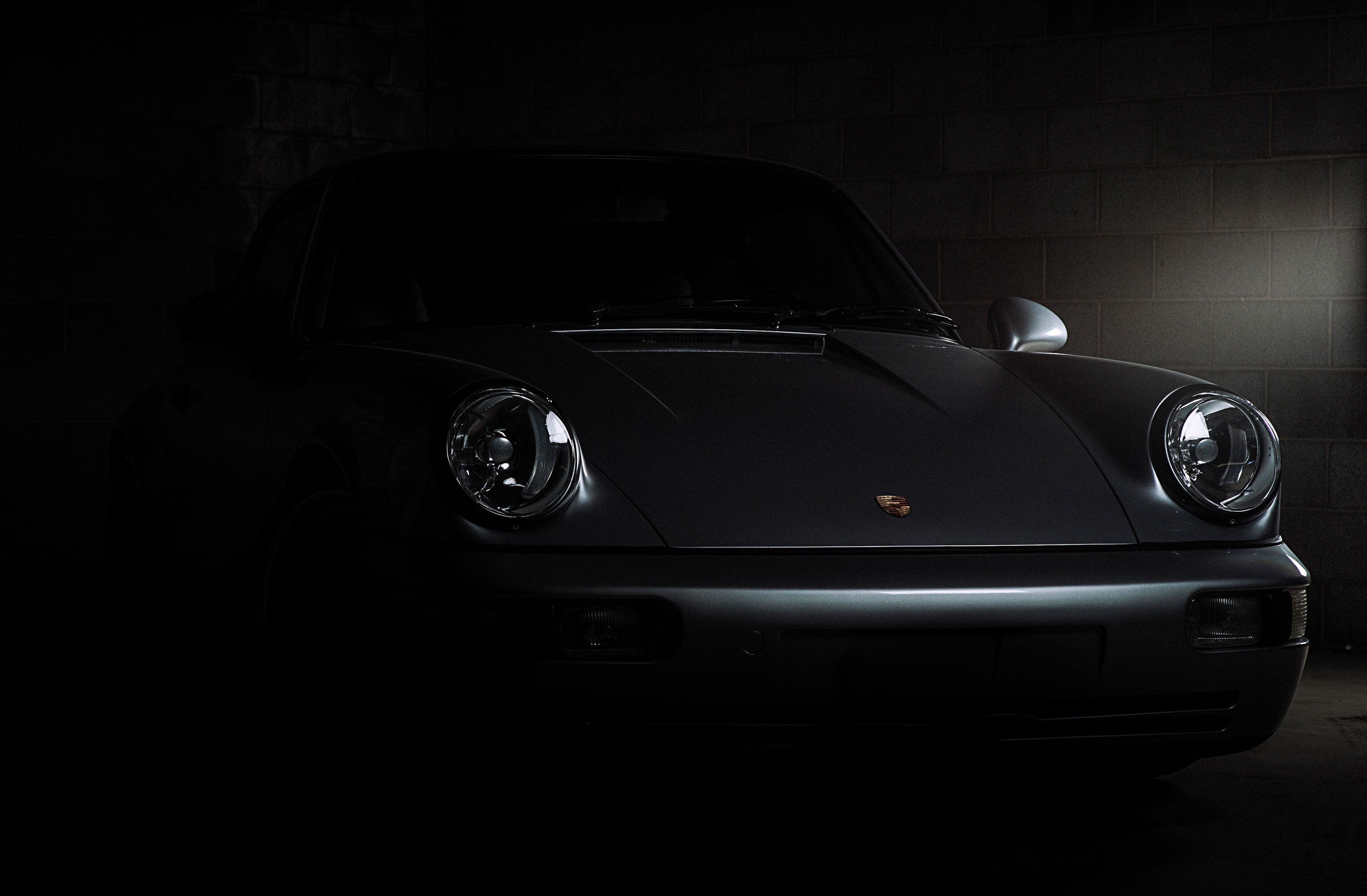 Classic Porsche 911 in dramatic garage lighting